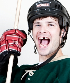 Photo of a man missing a tooth from a hockey injury in Victoria BC