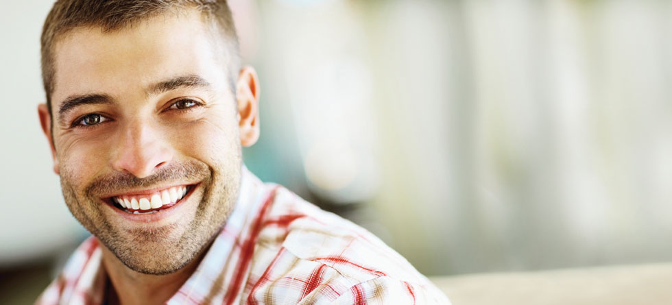 Smiling man with orthodontics in Victoria BC